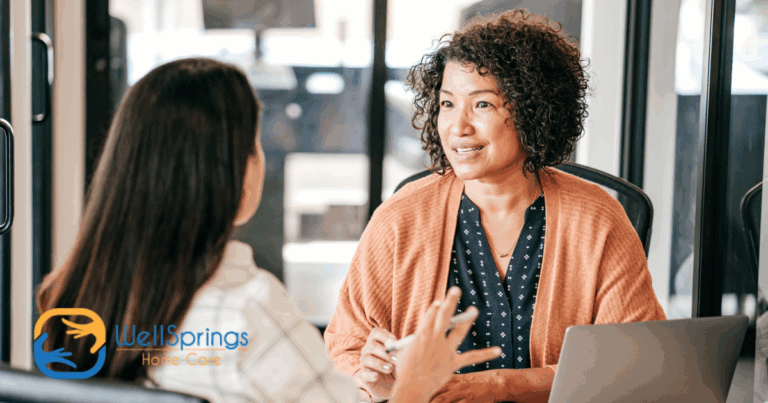 A woman interviews another woman for a caregiver job position.