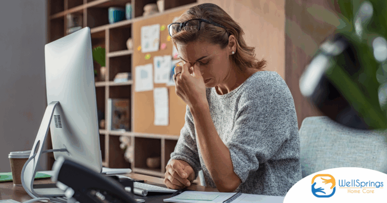 A woman is exhausted at her job as a result of struggling with balancing caregiving and her career.