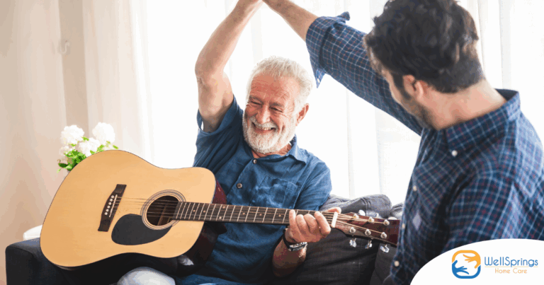 A smiling son high fives his happy elderly father as he plays the guitar, showing the positive effect music can have on people, including those with dementia.